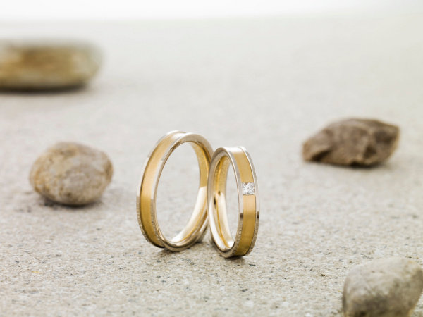 wedding rings balanced on stone