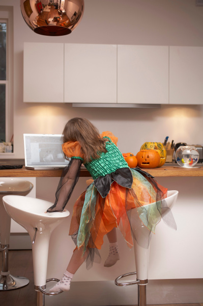 girl in halloween costume in kitchen
