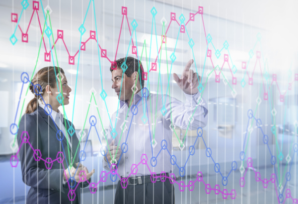 businessman and businesswoman discussing graph on