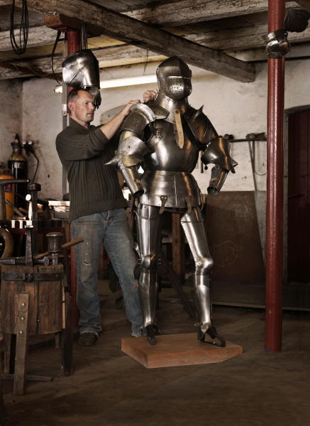 blacksmith crafting armor in shop