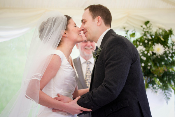 newlywed couple kissing in wedding