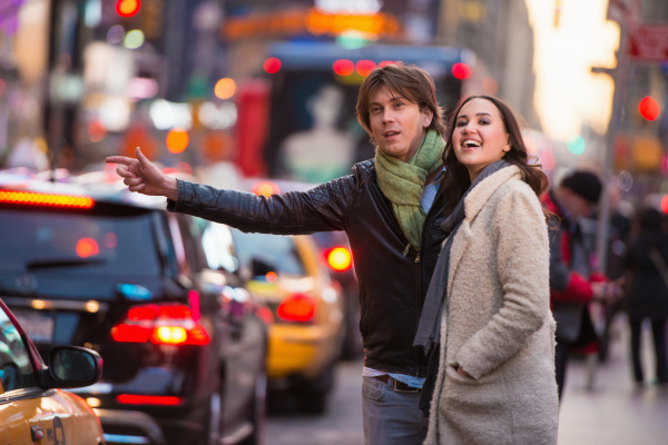 young tourist couple hailing a cab