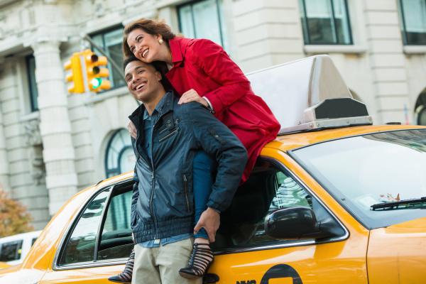 young tourist couple with yellow cab