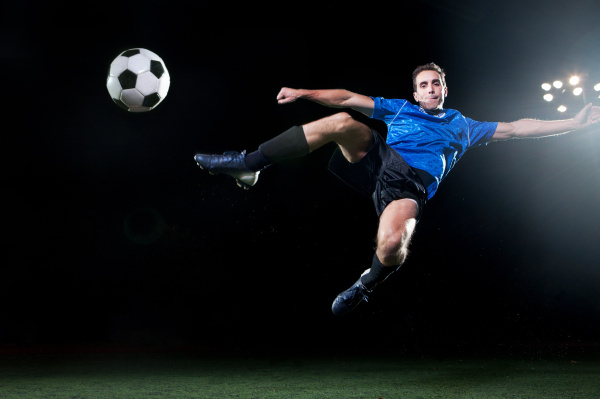 young soccer player leaping into air