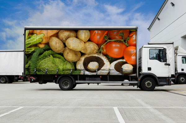 truck with vegetables parked outside distribution