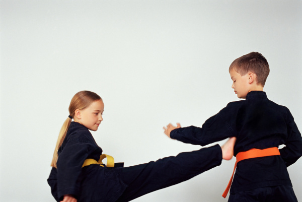 girl and boy practicing karate