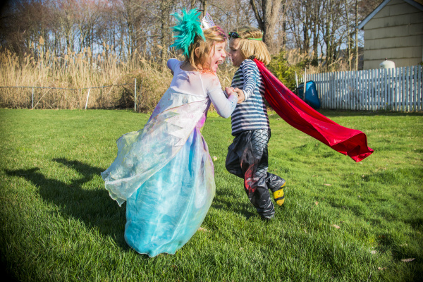 children in costumes playing outdoors