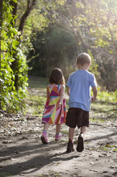 young boy and girl walking on