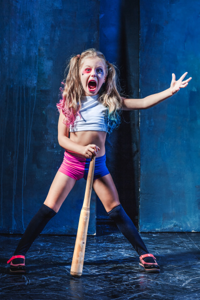 little girl pointing in toy gun