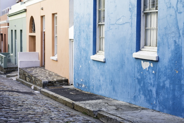 pastel colored homes on cobblestone street