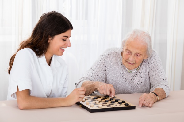 two women playing checkers game