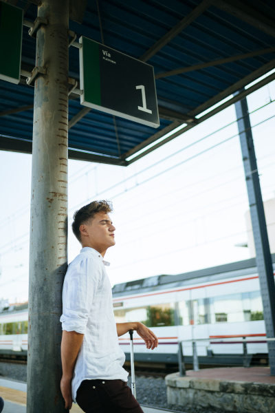 young man waiting at station platform