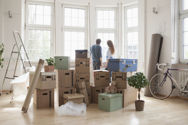 couple with cardboard boxes in new