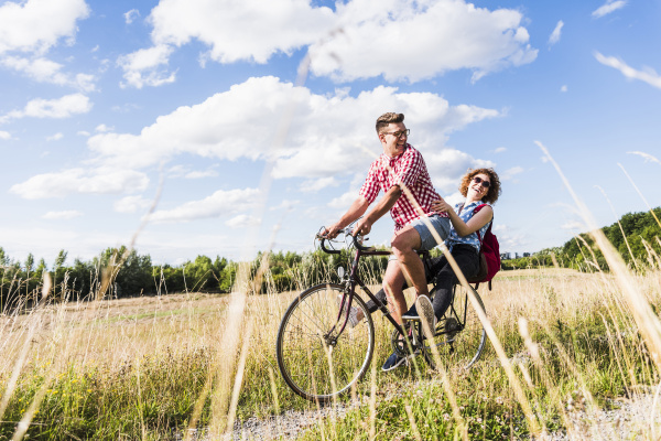 happy young couple on a bicycle