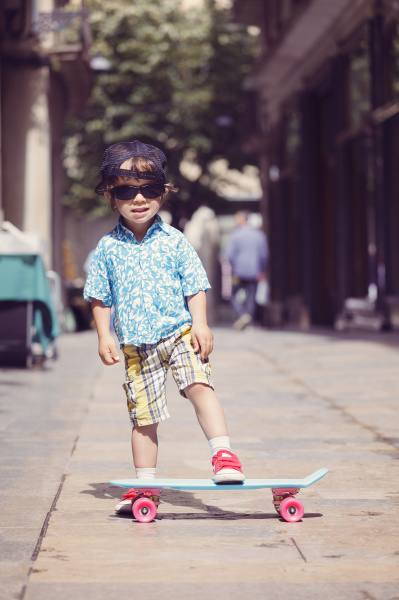 portrait of little boy with skateboard