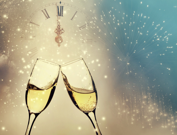 glasses with champagne and clock close