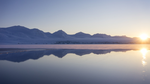 reflection of snowy mountains in arctic