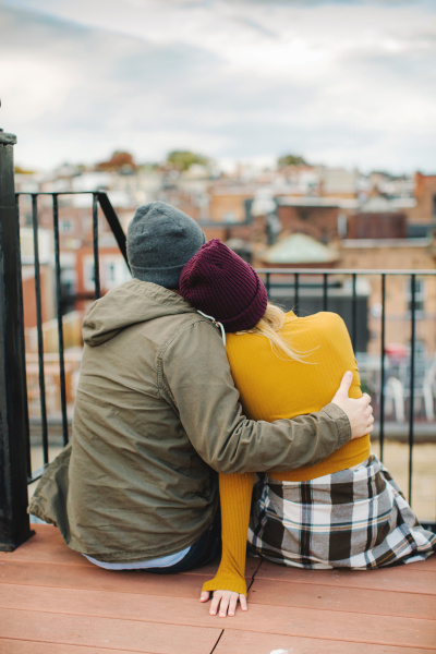 young couple sitting looking out from