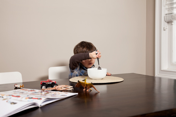 boy at table with bowl of