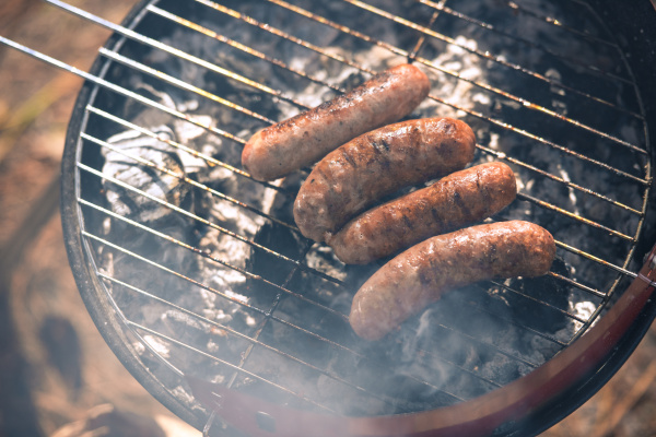 grilling sausages on barbecue grill