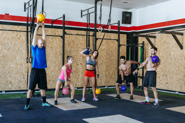 group of athletes lifting kettlebells in