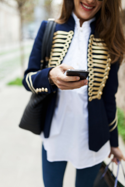 fashionable young woman using cell phone