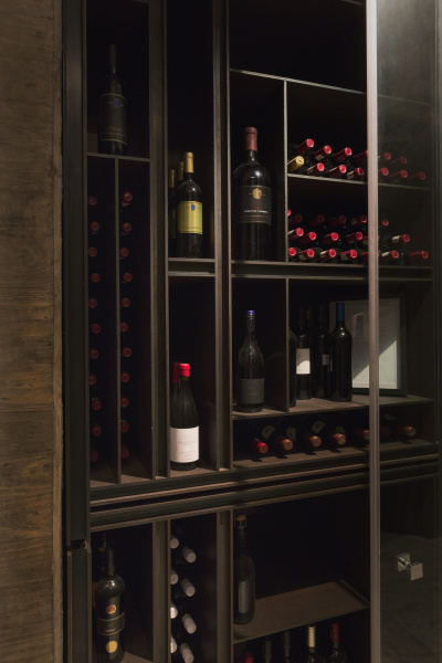 wine bottles organized on wooden shelves