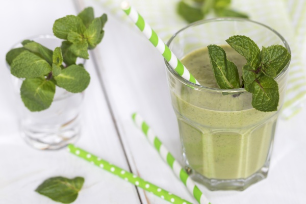 glass of green smoothie garnished with