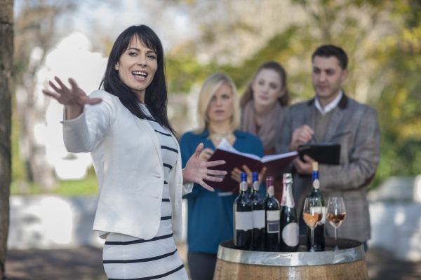 wine saleswoman with group of clients