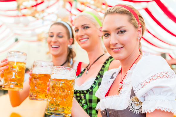 friends drinking bavarian beer at oktoberfest