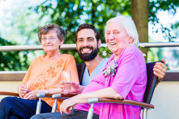 Nurse drinking coffee with seniors on terrace - Stock Photo #21499349 ...