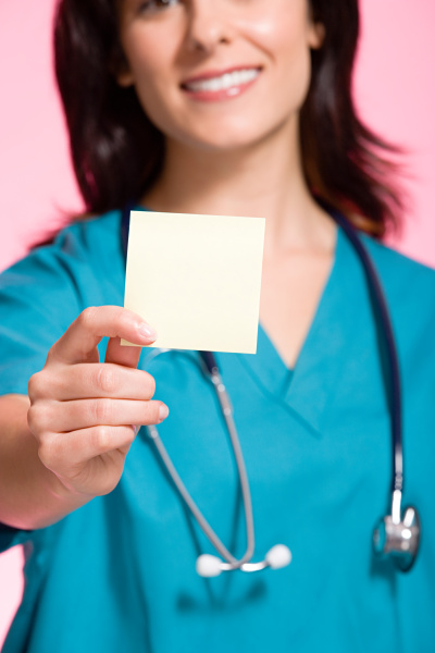 female nurse holding an adhesive note