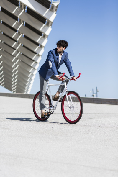 young businessman on fixie bike outdoors