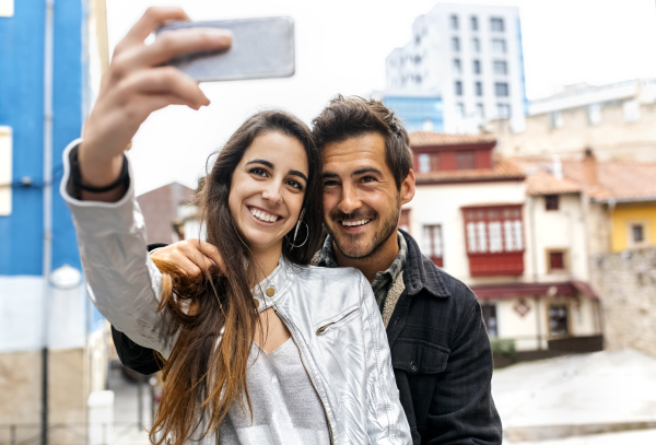 smiling couple taking a selfie in