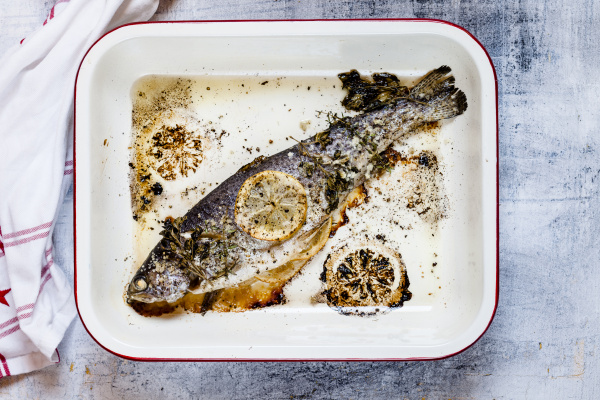 roasting dish of baked salmon trout