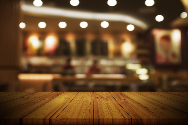 Empty wooden table top with blurred restaurant or cafe - Stock Photo ...