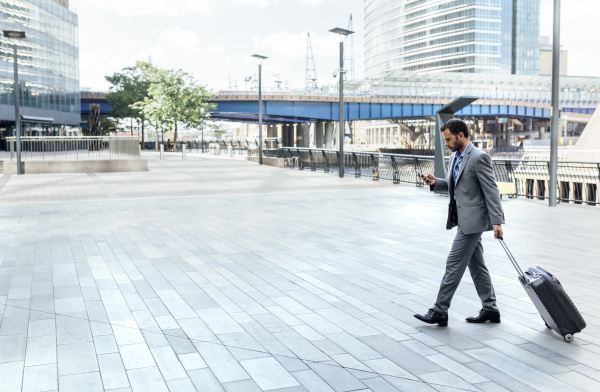 businessman walking through the city with