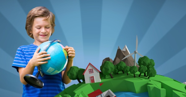 smiling boy holding globe while standing