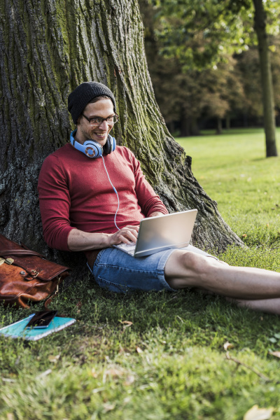 man using laptop in park