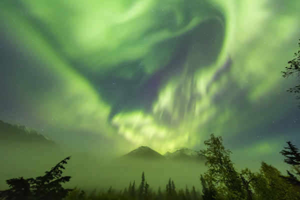 bright green aurora borealis dances over