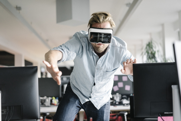 businessman wearing vr glasses in office