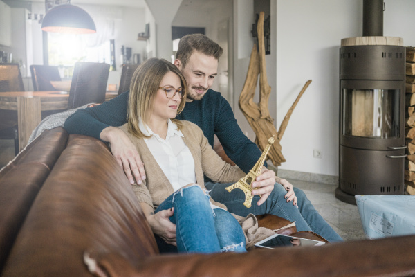 smiling couple sitting on couch at