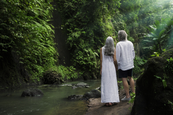 handsome senior couple in tropical waterfall
