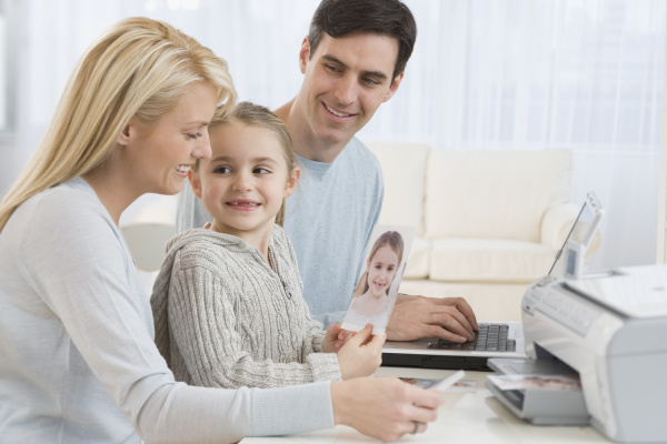 family printing pictures with laptop