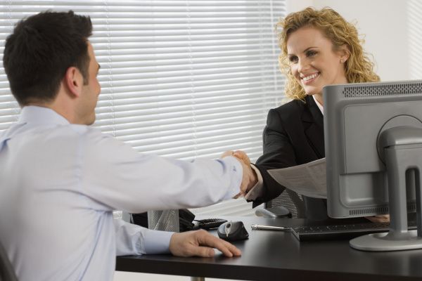 businesswoman consulting with businessman at desk