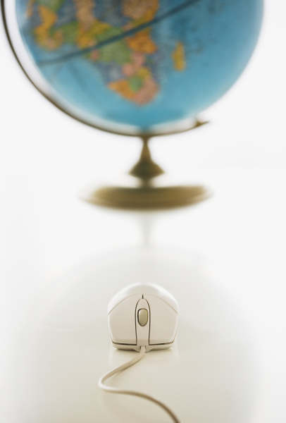 computer mouse in front of globe