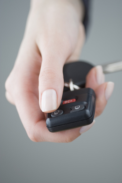 woman pressing unlock button on keychain