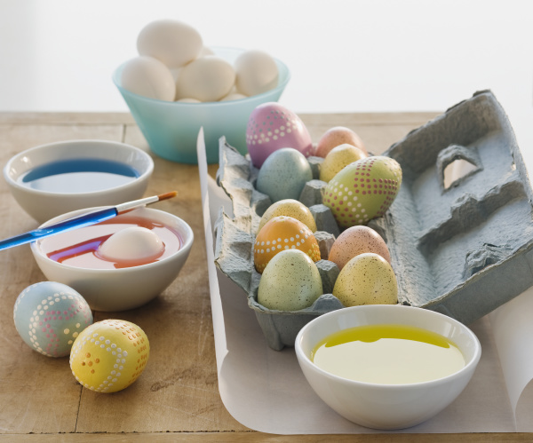 decorated eggs next to bowls of