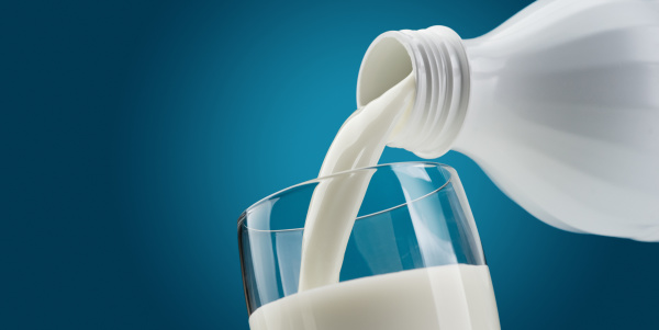 pouring fresh milk into a glass