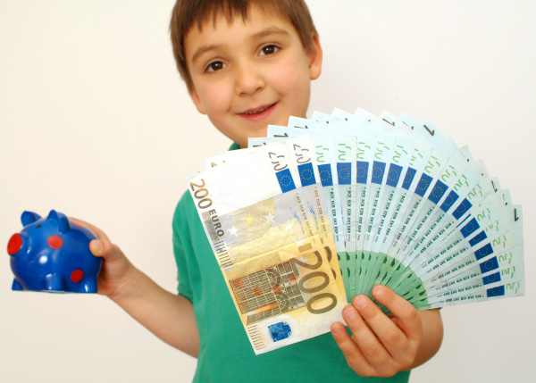 boy with piggy bank and banknotes